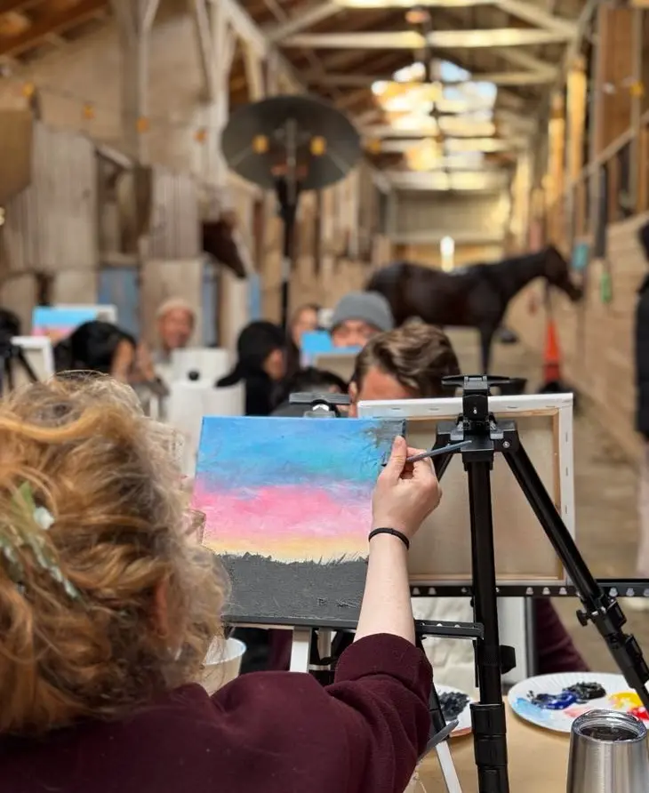Painted Trail guests painting with horses nearby